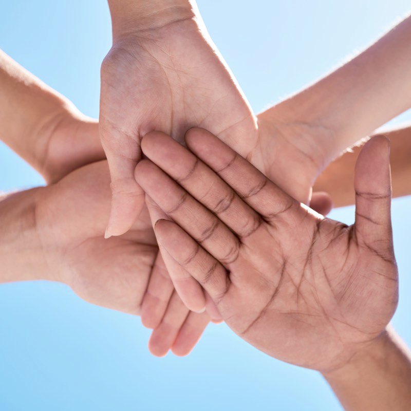 Hands resting on top of one another.