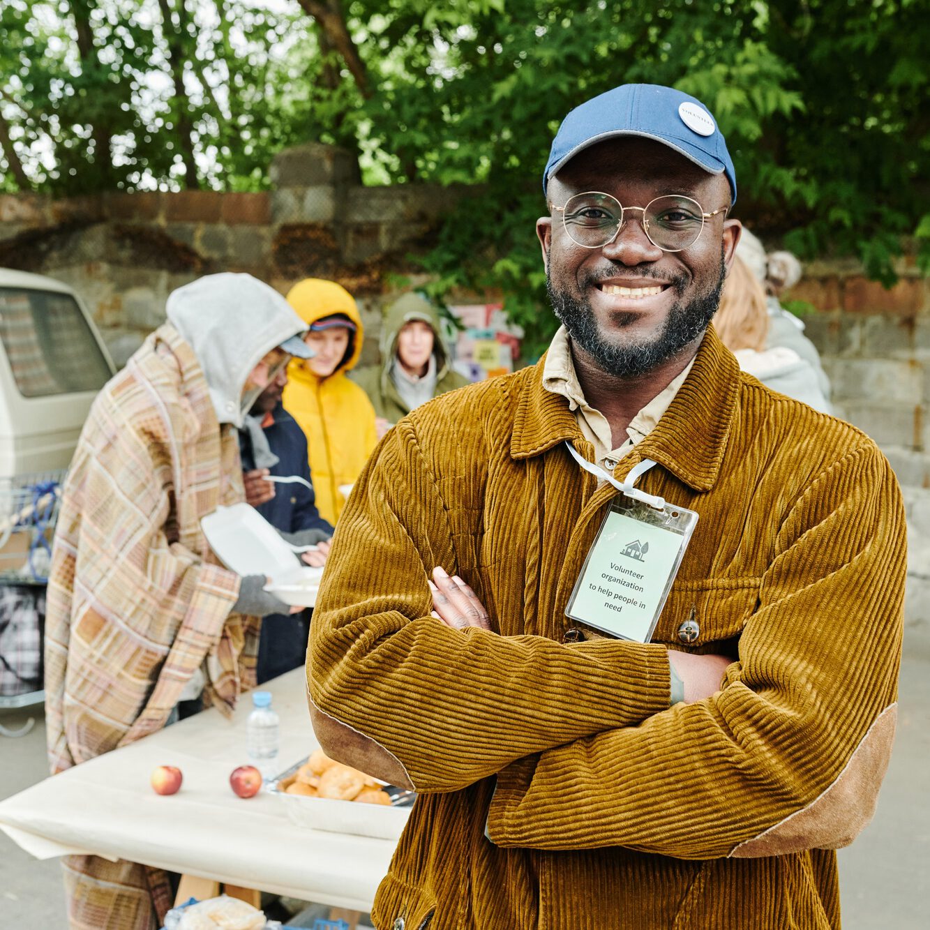 Volunteer helping homeless people outdoors